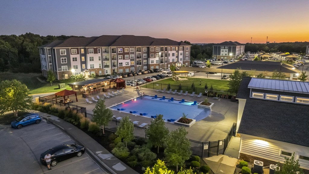 an aerial view of an outdoor pool at dusk