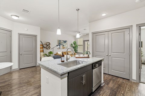 A modern kitchen with a white countertop and dark wood cabinets.