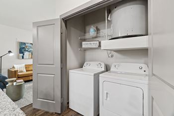 A laundry room with a washer and dryer in a cabinet.