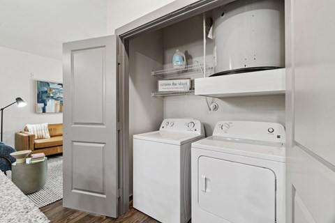 A laundry room with a washer and dryer in a cabinet.