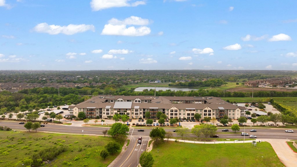 A large building with a parking lot in front of it.