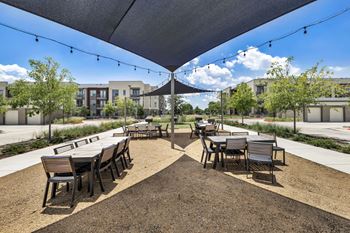 an outdoor patio with tables and chairs