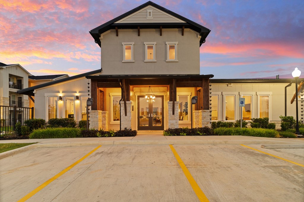 A large house with a driveway in front of it.