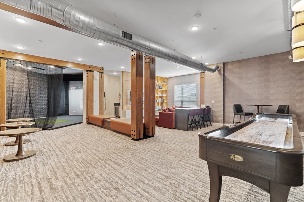 a game room with a pool table and a bar