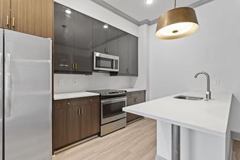a kitchen with white countertops and stainless steel appliances