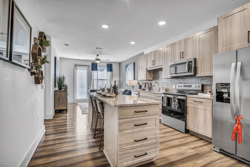 a kitchen with wooden cabinets and stainless steel appliances