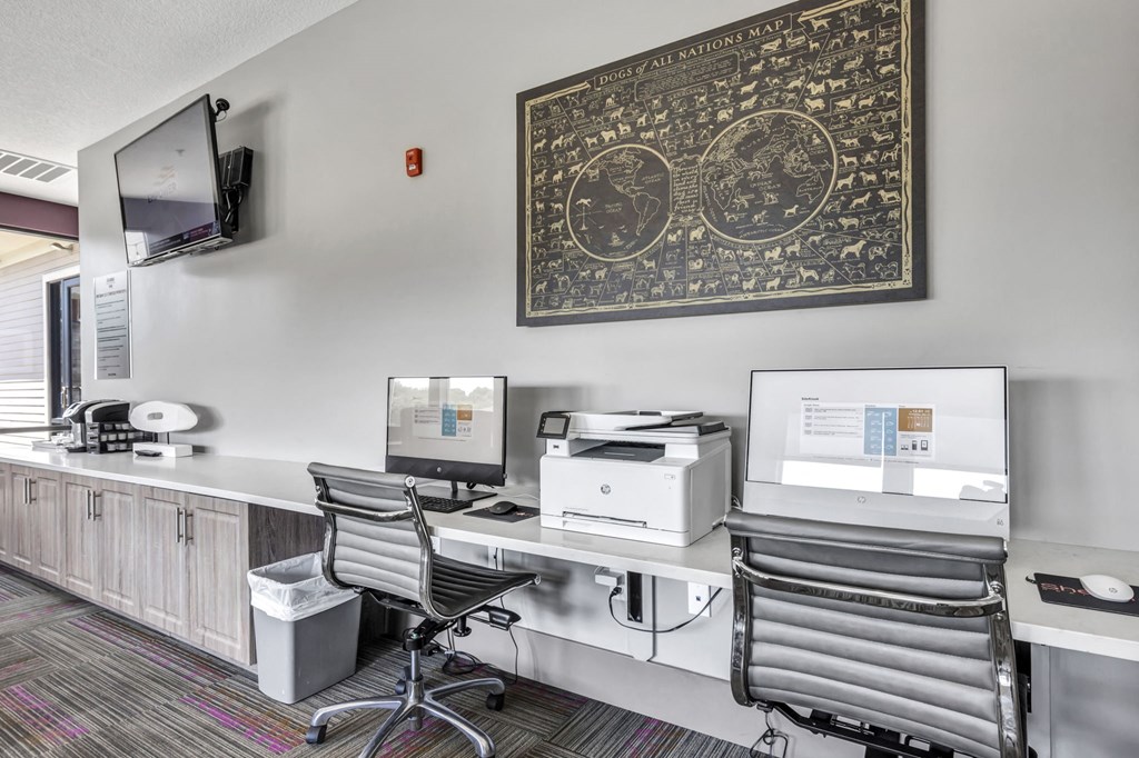 an office with two desks and a printer and a monitor