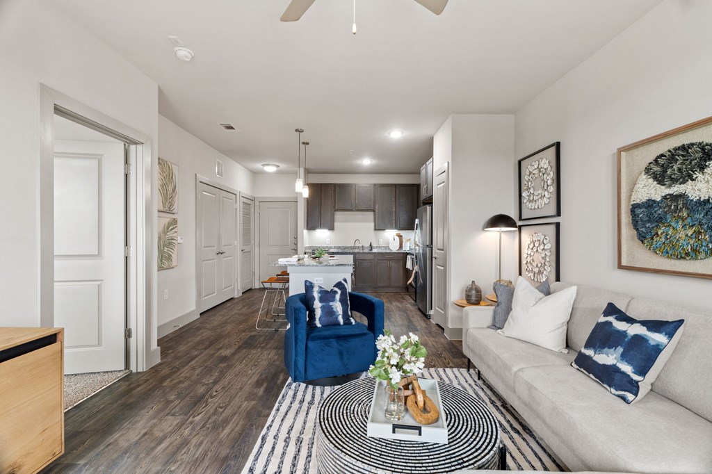 A modern living room with a blue armchair and a coffee table.
