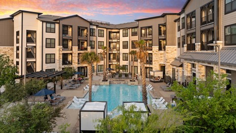 A large apartment complex with a pool and patio area.