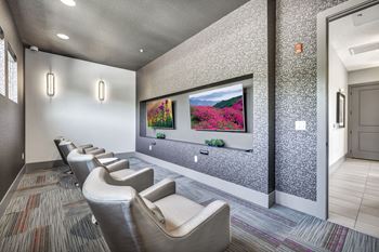 Two televisions with chairs for video gaming