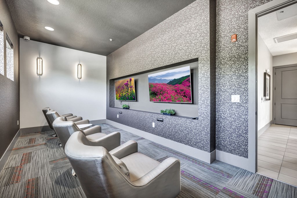 a waiting room with chairs and a tv on the wall