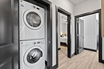 a white washer and dryer in a room with a door
