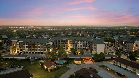 A large hotel complex with a pool and multiple buildings.