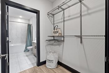 a bathroom with a shower and a door with a bag in it