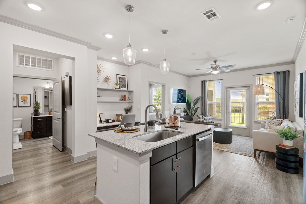 A modern kitchen with a large island and stainless steel appliances.