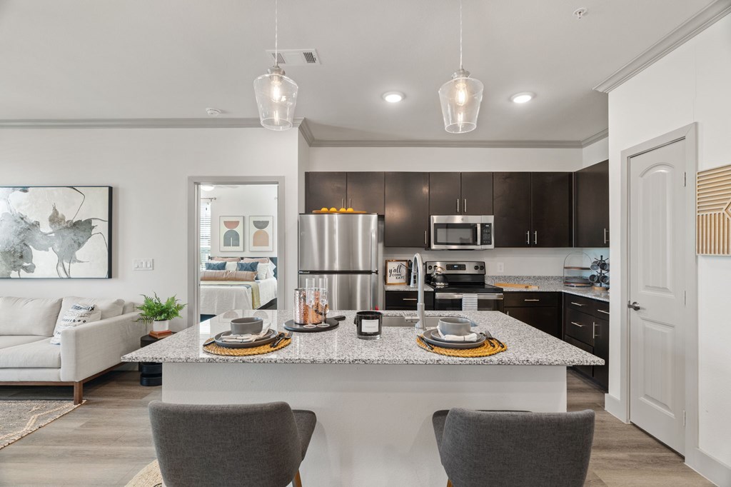 A modern kitchen with a dining table and chairs.