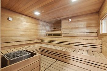 a sauna with wooden walls and benches and a window