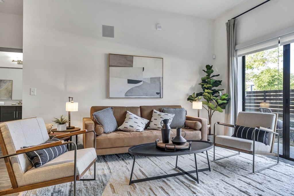 a living room with a couch chairs and a coffee table