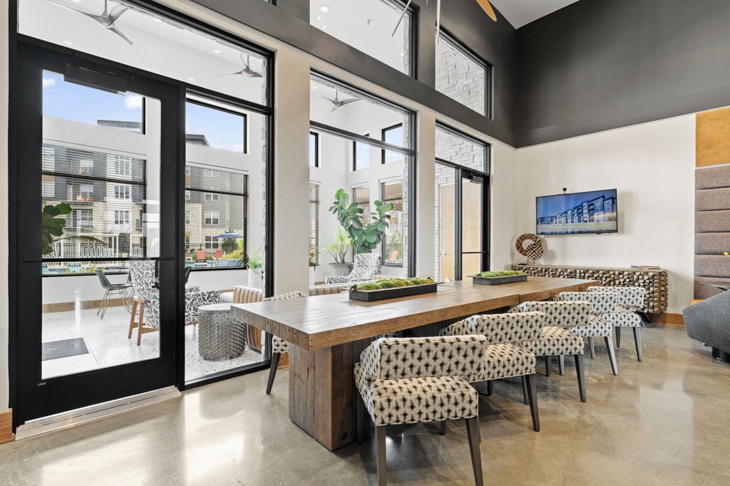 a dining room with a long wooden table and chairs