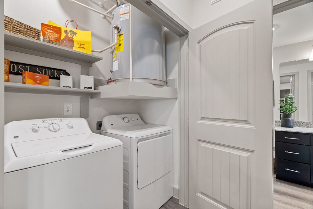 A white washing machine and dryer in a small laundry room.