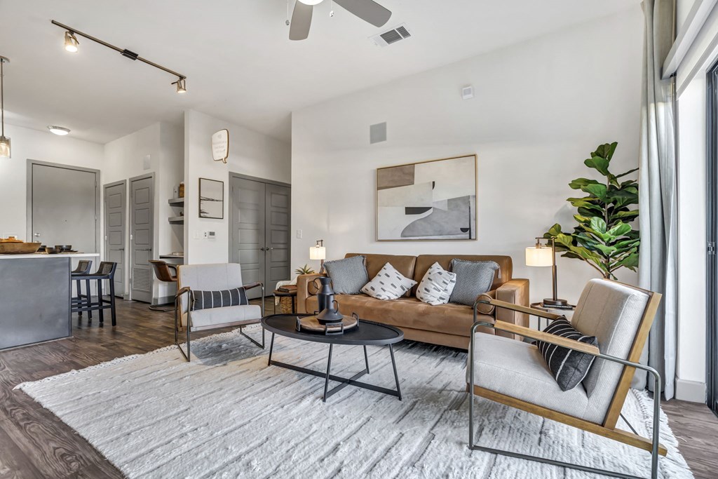 a living room with a couch chairs and a coffee table