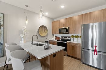 a kitchen with stainless steel appliances and a white counter top