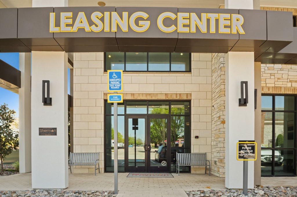 The leasing center has a parking sign on the wall.