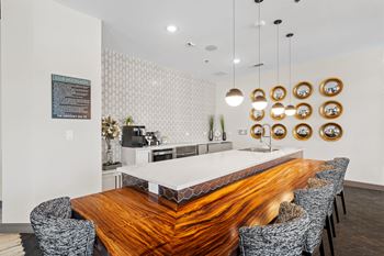 A modern dining room with a wooden table and chairs.