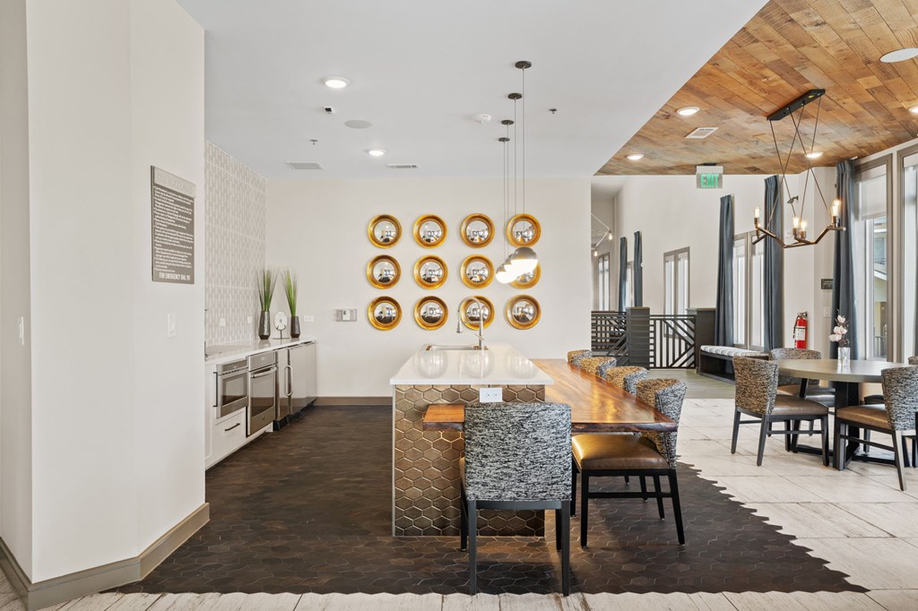 A modern dining room with a wooden table and chairs.