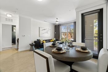 A dining room with a round table set for six.
