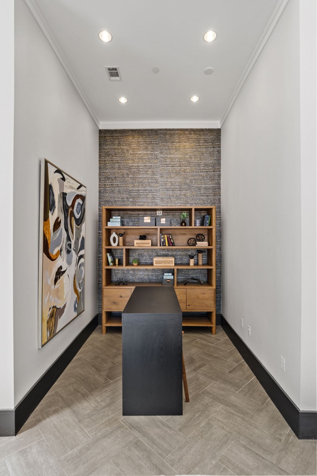 A room with a brick wall and a bookshelf.