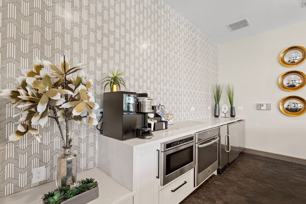A modern kitchen with a white countertop and stainless steel appliances.