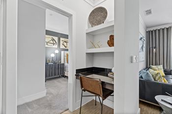 A room with a desk and a chair in it.