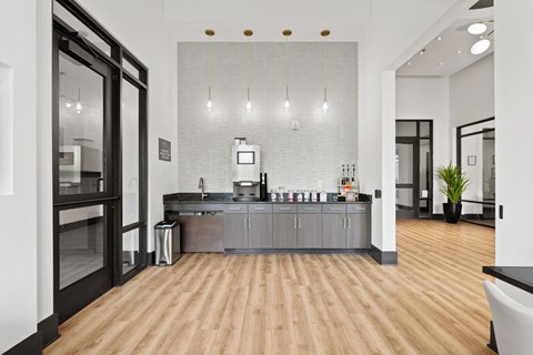 A modern kitchen with wooden floors and a central island.