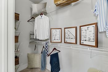 A white shirt hanging on a rack with three framed diagrams below it.