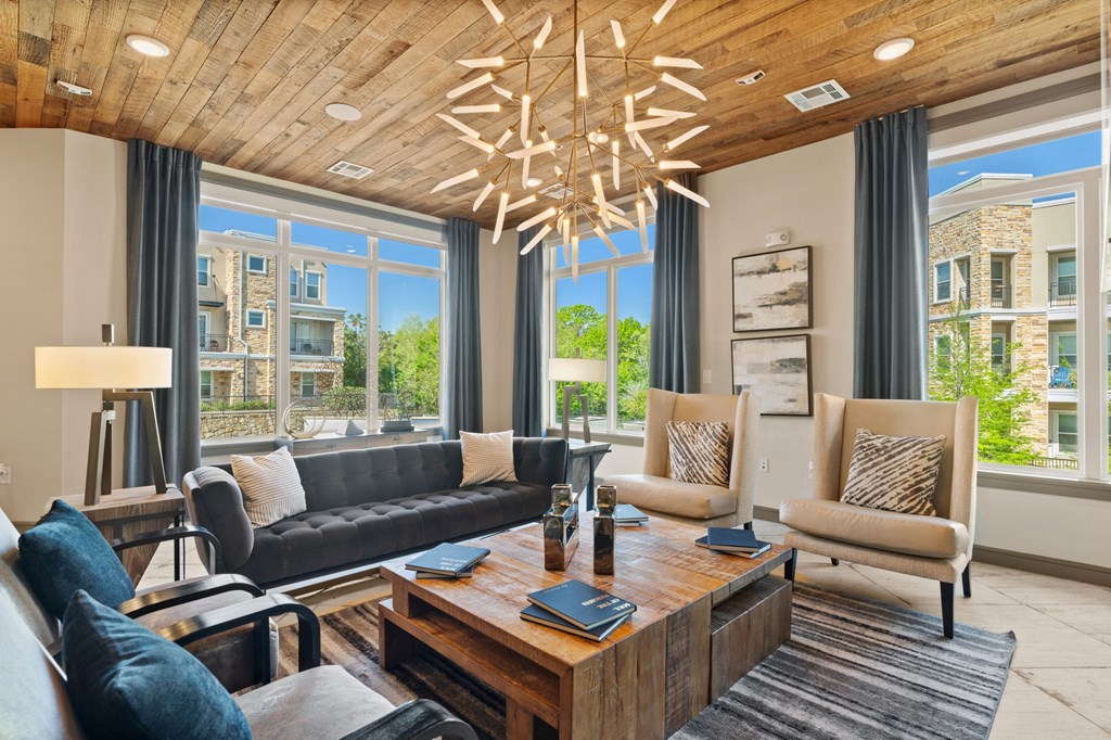 A modern living room with a large window and a view of a building outside.