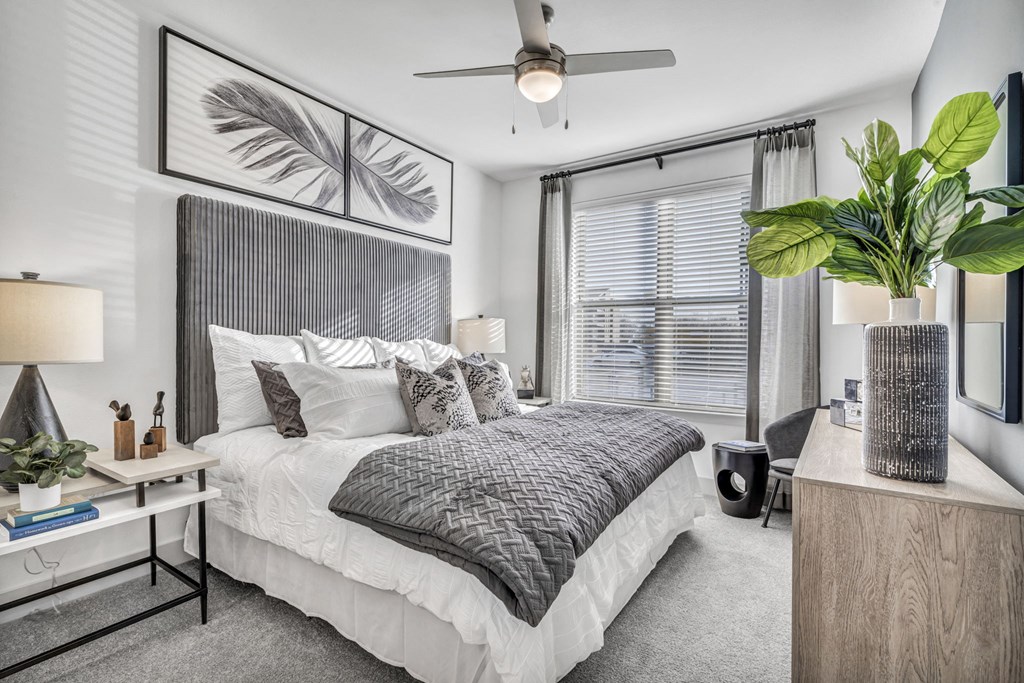 a bedroom with a bed and a ceiling fan