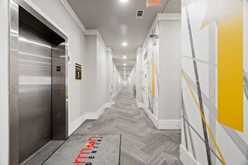 A long hallway with a red carpet that says "Virgin Atlantic" on it.
