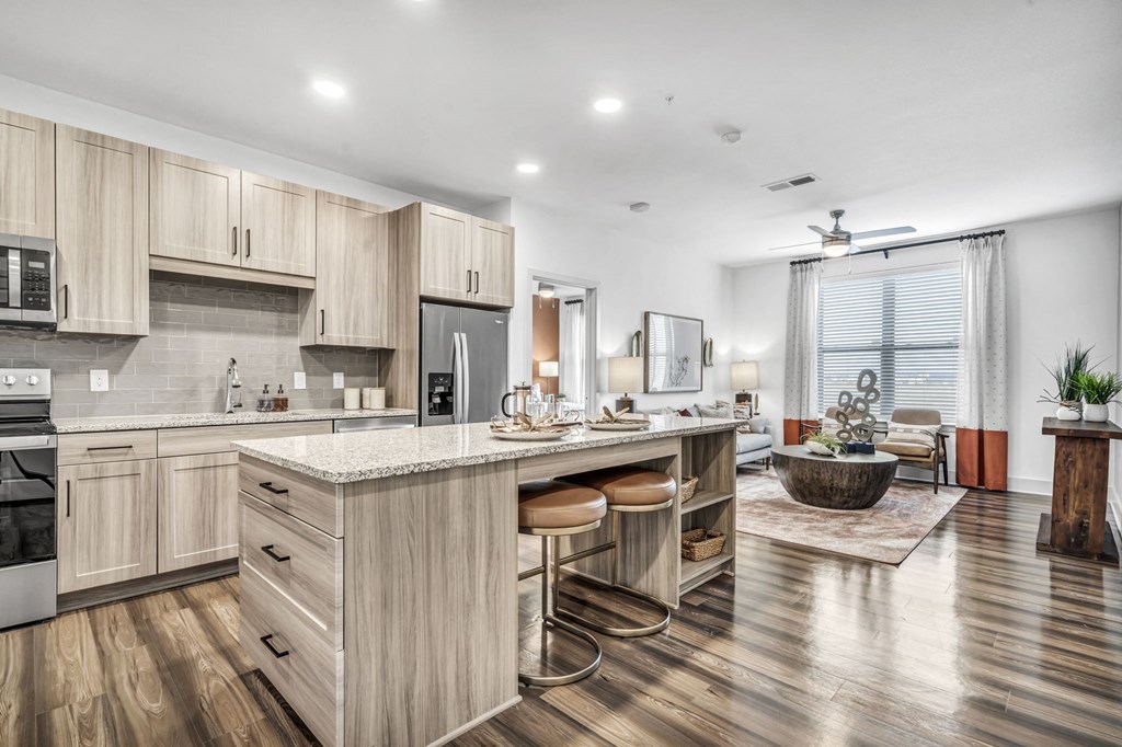 a kitchen with a large island and a living room