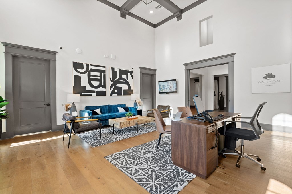 a living room with a desk and a couch