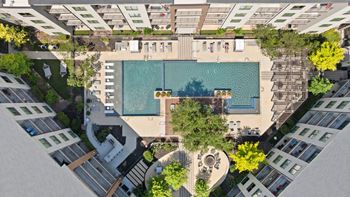 A swimming pool surrounded by buildings and trees.