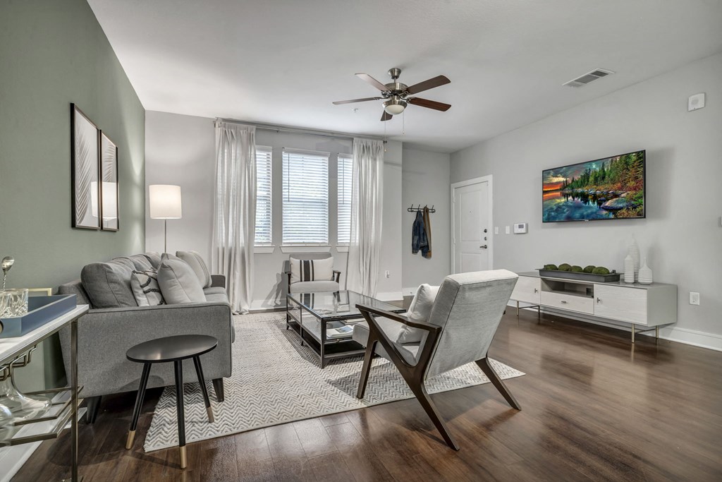 a living room with furniture and a ceiling fan