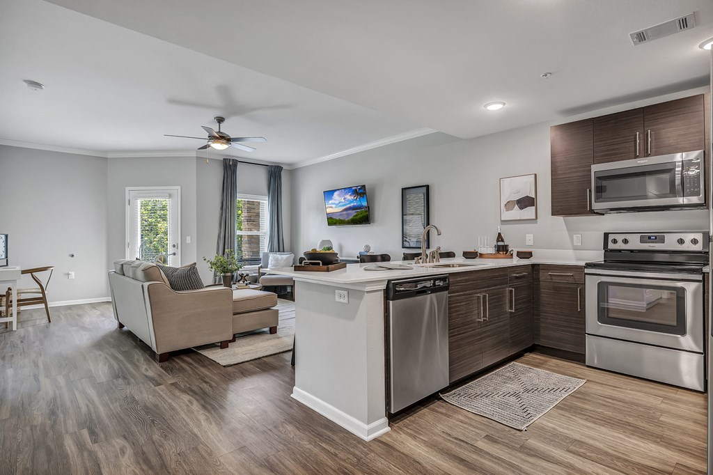 a living room with a kitchen and a couch