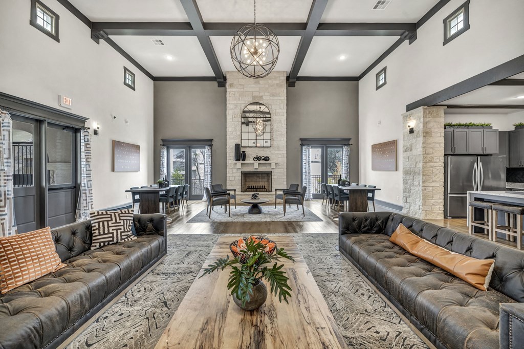 a living room with couches and a table and a fireplace
