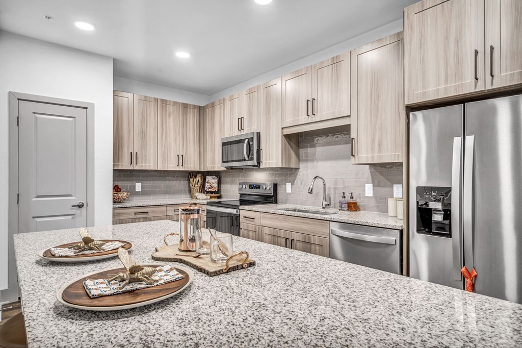 a kitchen with stainless steel appliances and granite counter tops