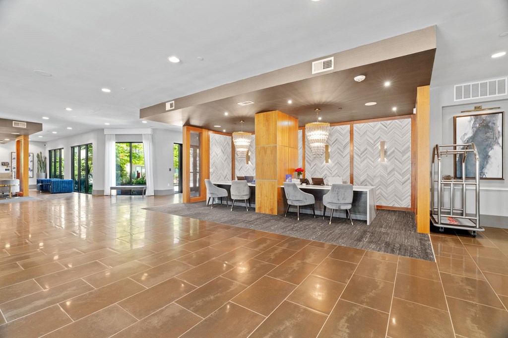 A spacious lobby with a marble floor and a reception desk.