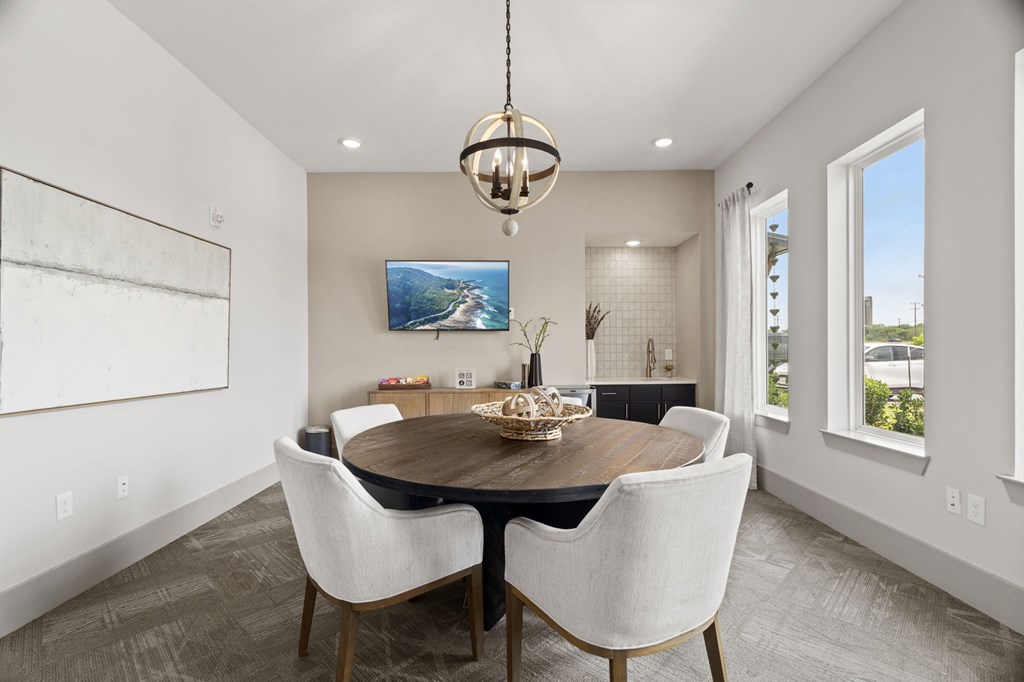 A modern dining room with a wooden table and chairs.