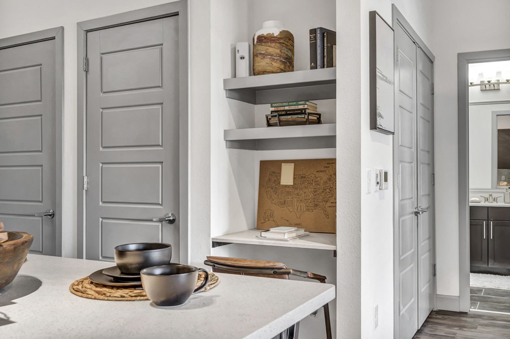 a kitchen with white walls and white countertops with a white table and a white countertop