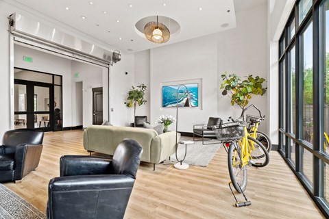 A yellow bicycle is parked in a waiting room.