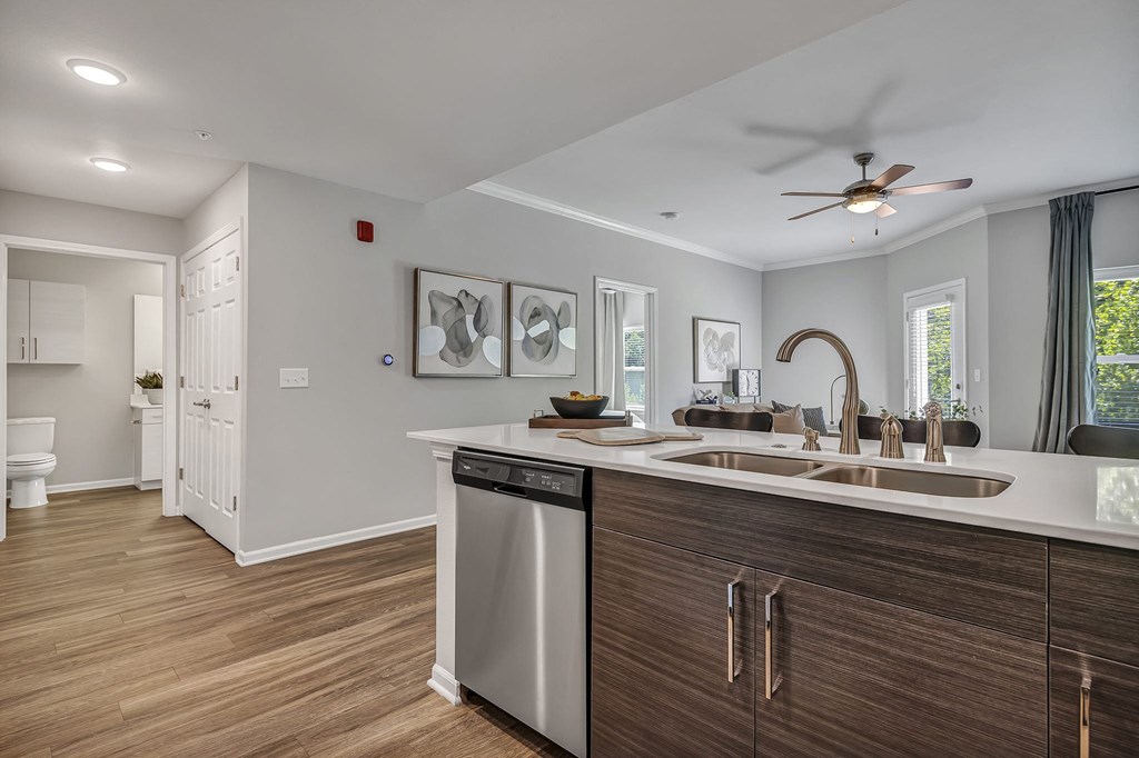 a kitchen with a sink and a ceiling fan